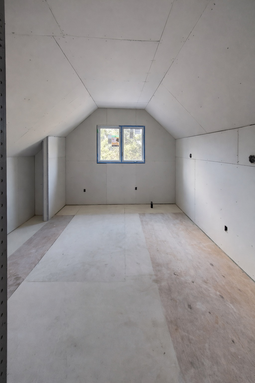 Attic-conversion drywall — sloped ceilings boarded and ready for finishing, Toronto