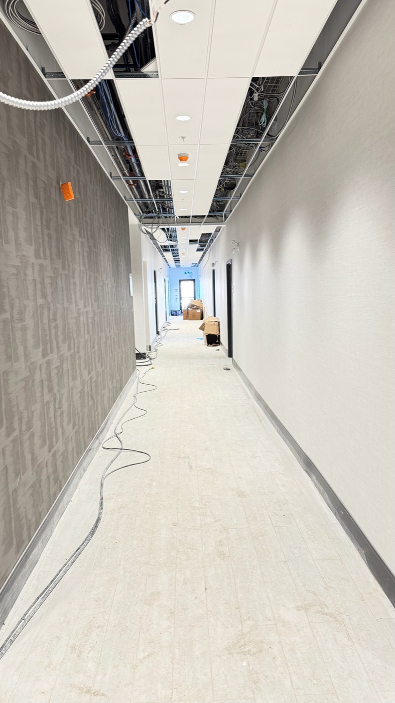 T-bar grid being installed in a hotel corridor