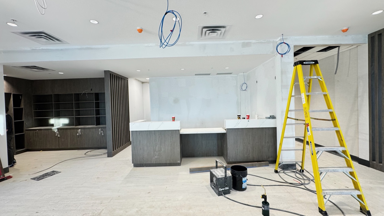 Paint-ready drywall at the hotel front desk and lobby