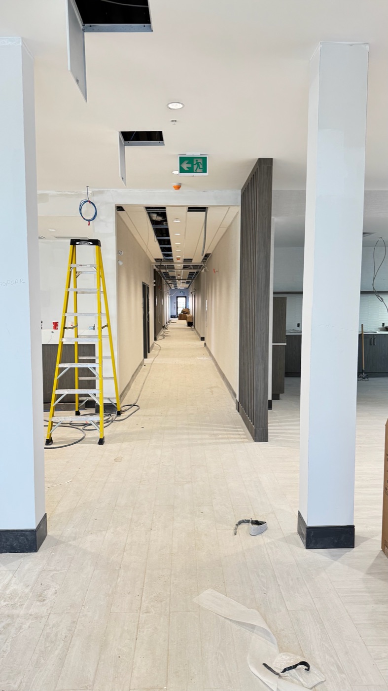 Paint-ready drywall columns and bulkheads in a commercial lobby in Ontario