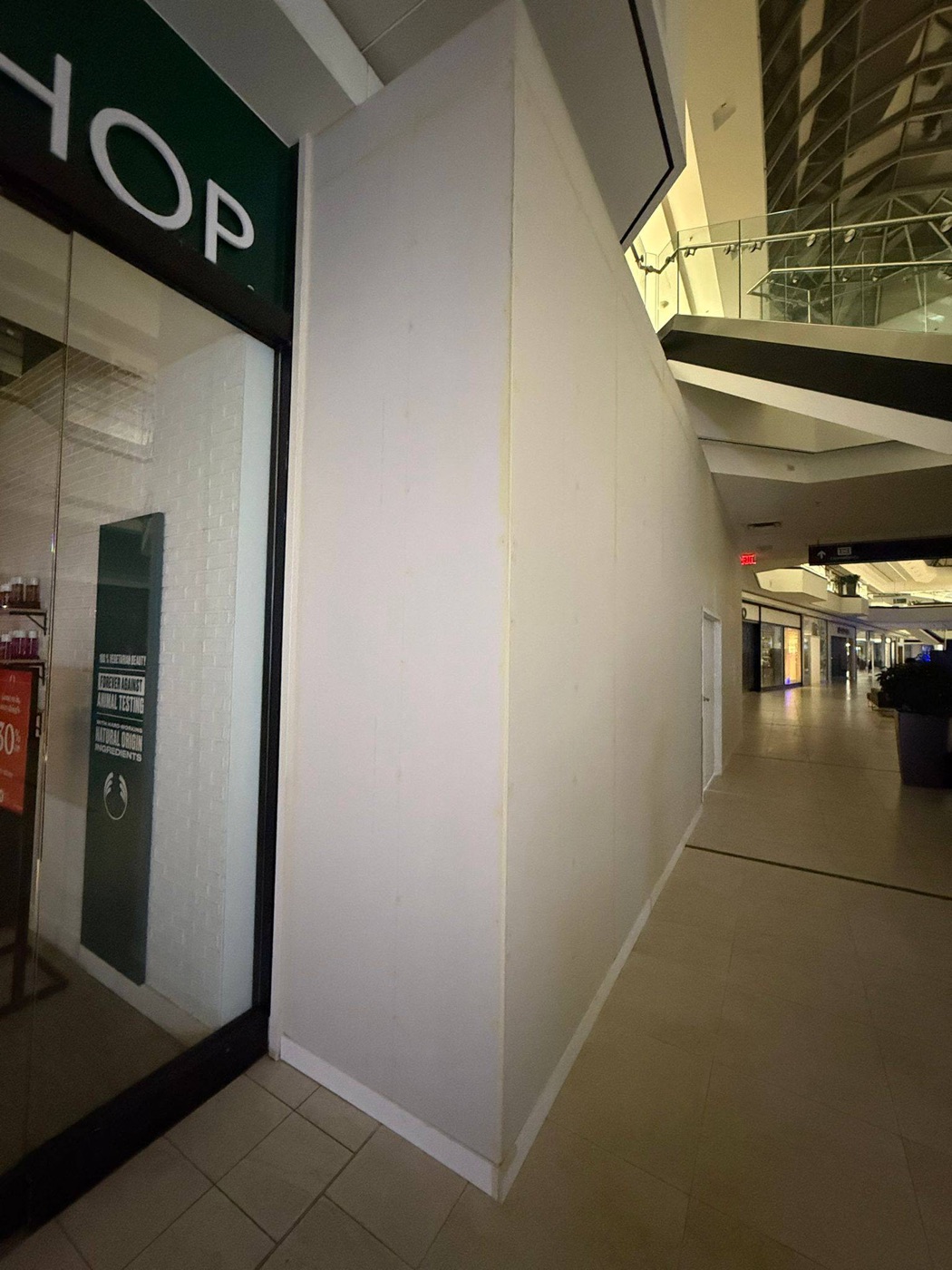 New finished drywall hoarding wall with access door at a KFC unit in a GTA mall