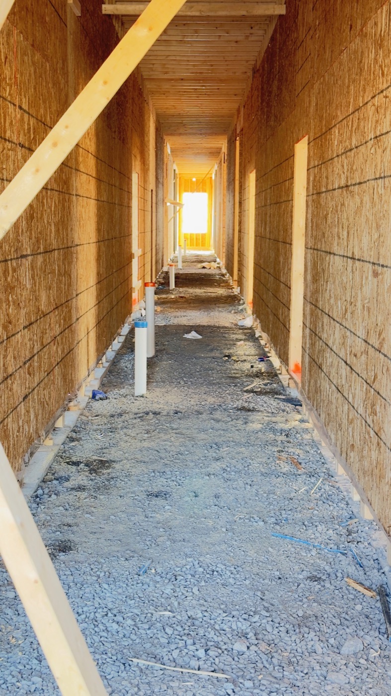 Hotel corridor in early construction, before interior drywall finishing